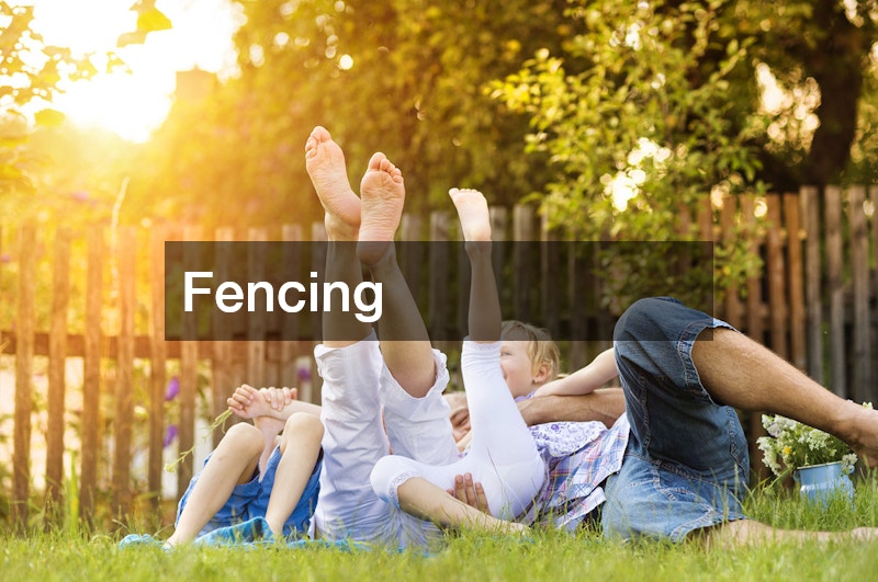 family on a lawn with fence